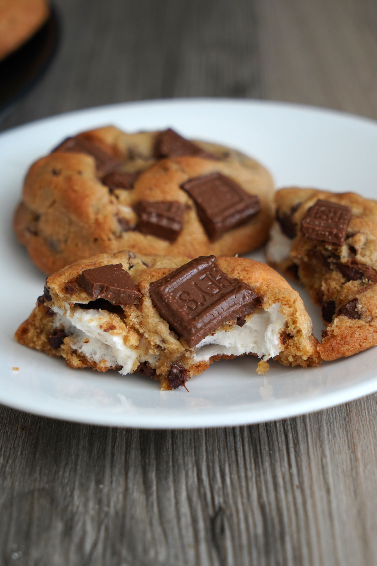 Broken stuffed s'mores cookie revealing the inside stuffing. 