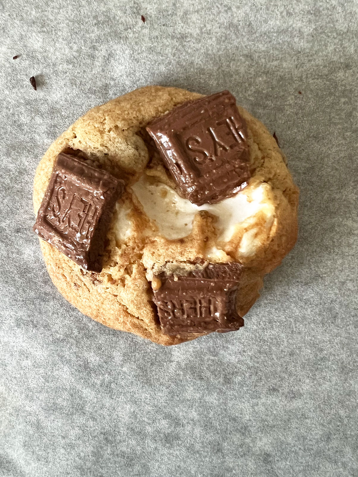 Just baked s'mores cookie cooling on parchment paper.