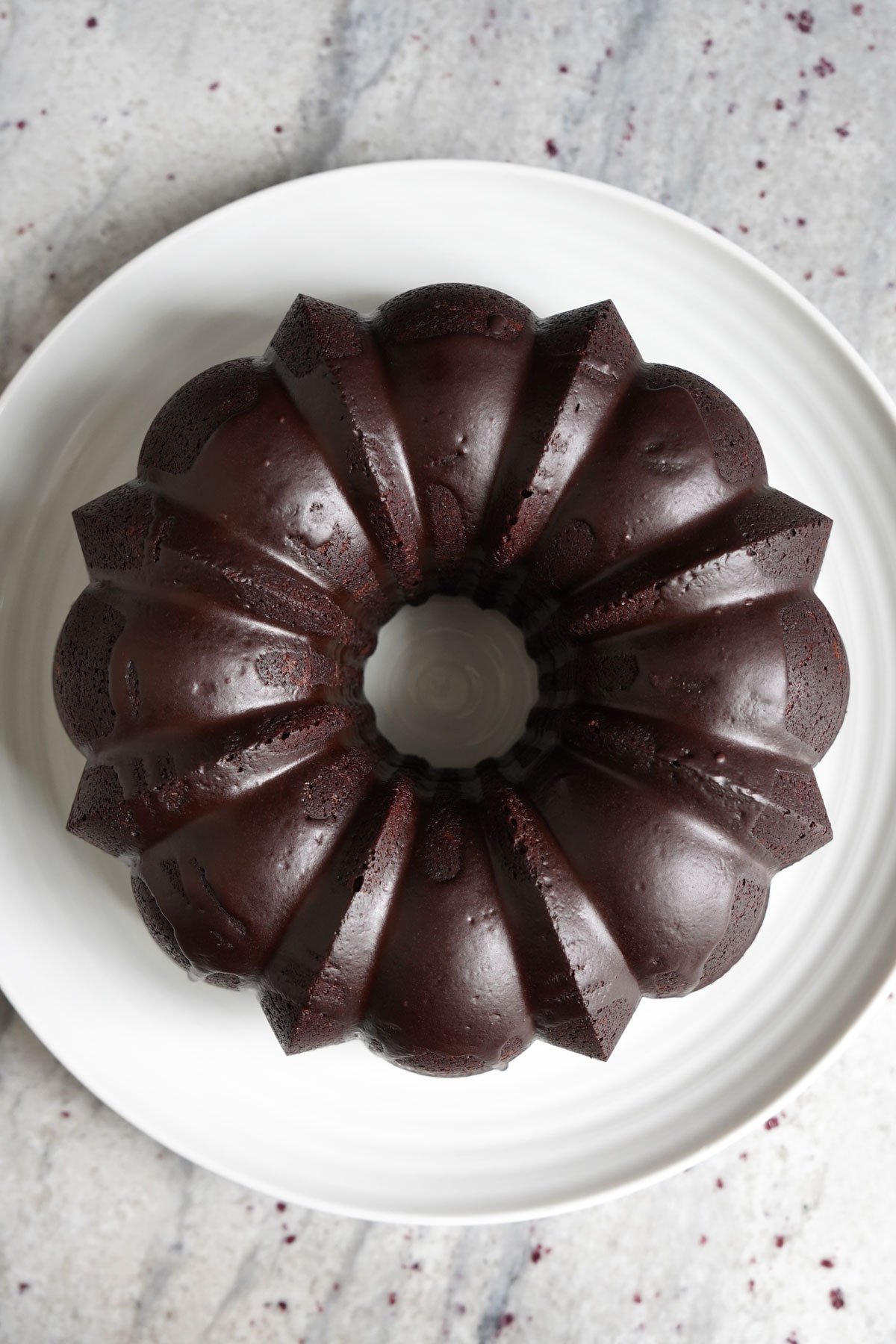 Top view of bundt cake on white platter/.