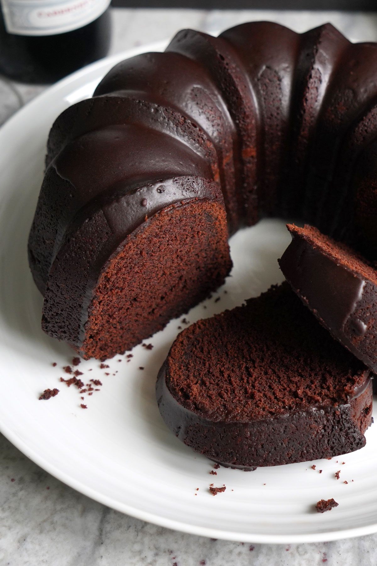 Red wine chocolate bundt cake with slices cut.