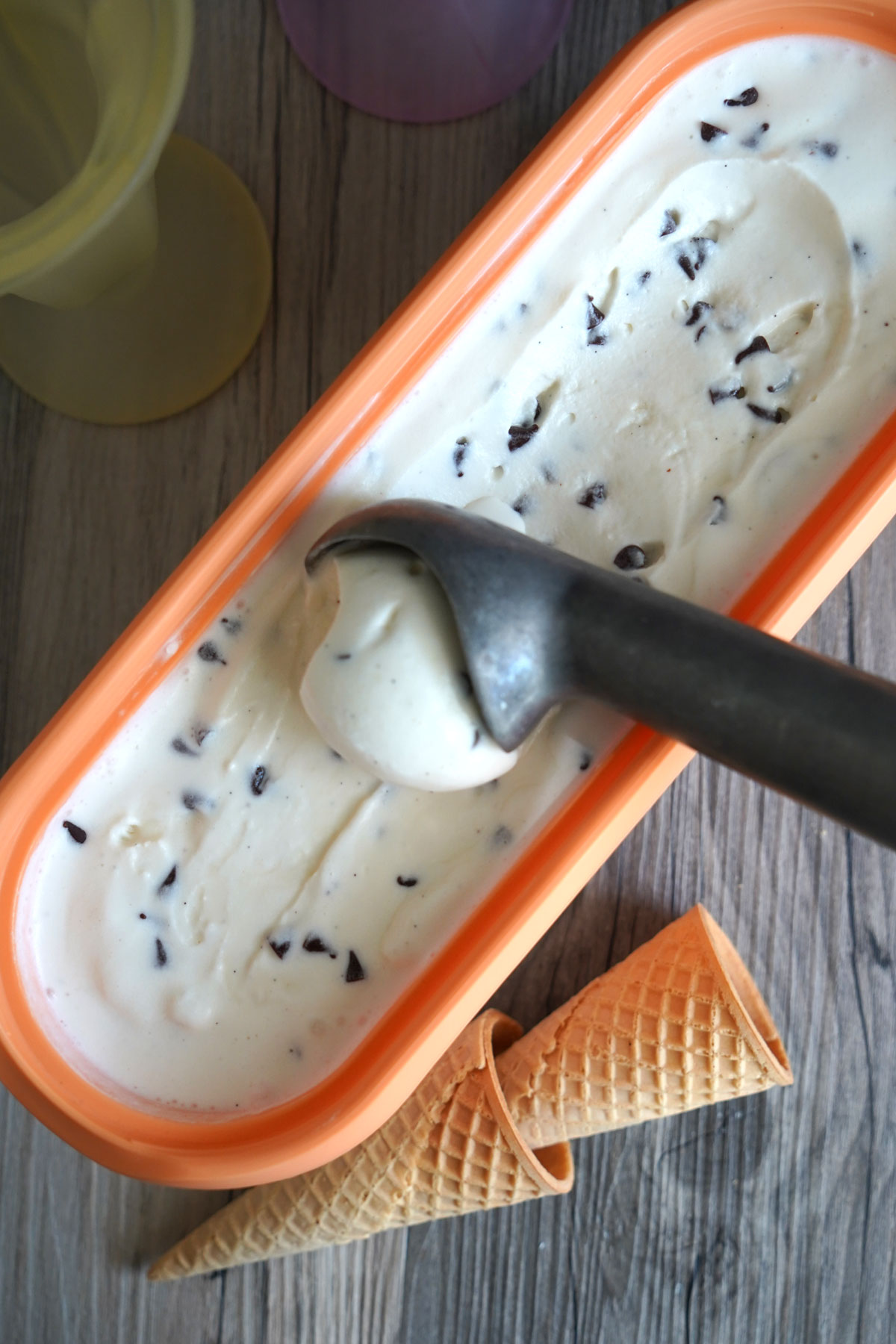 Top view of ice cream being scooped out of container.