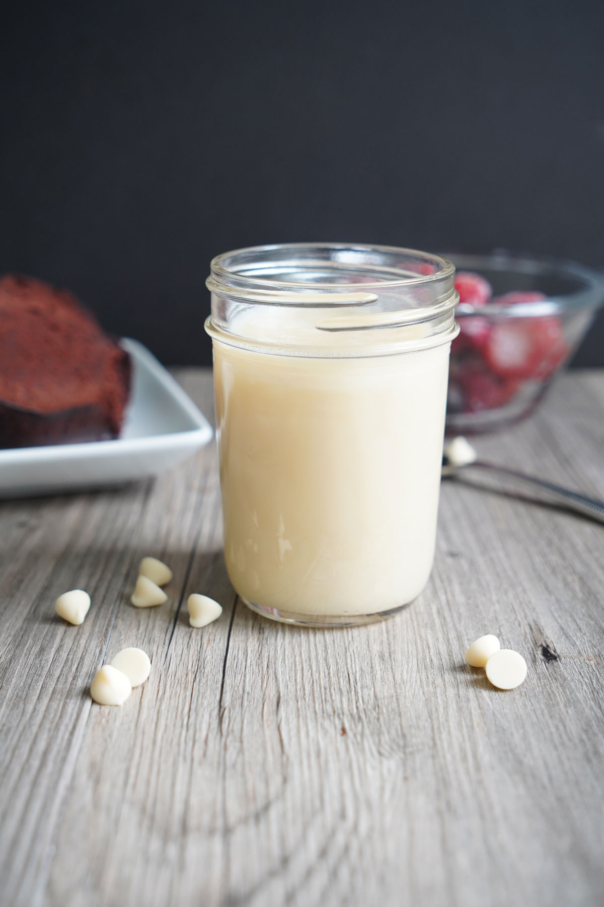 White chocolate sauce cooling in glass jar.