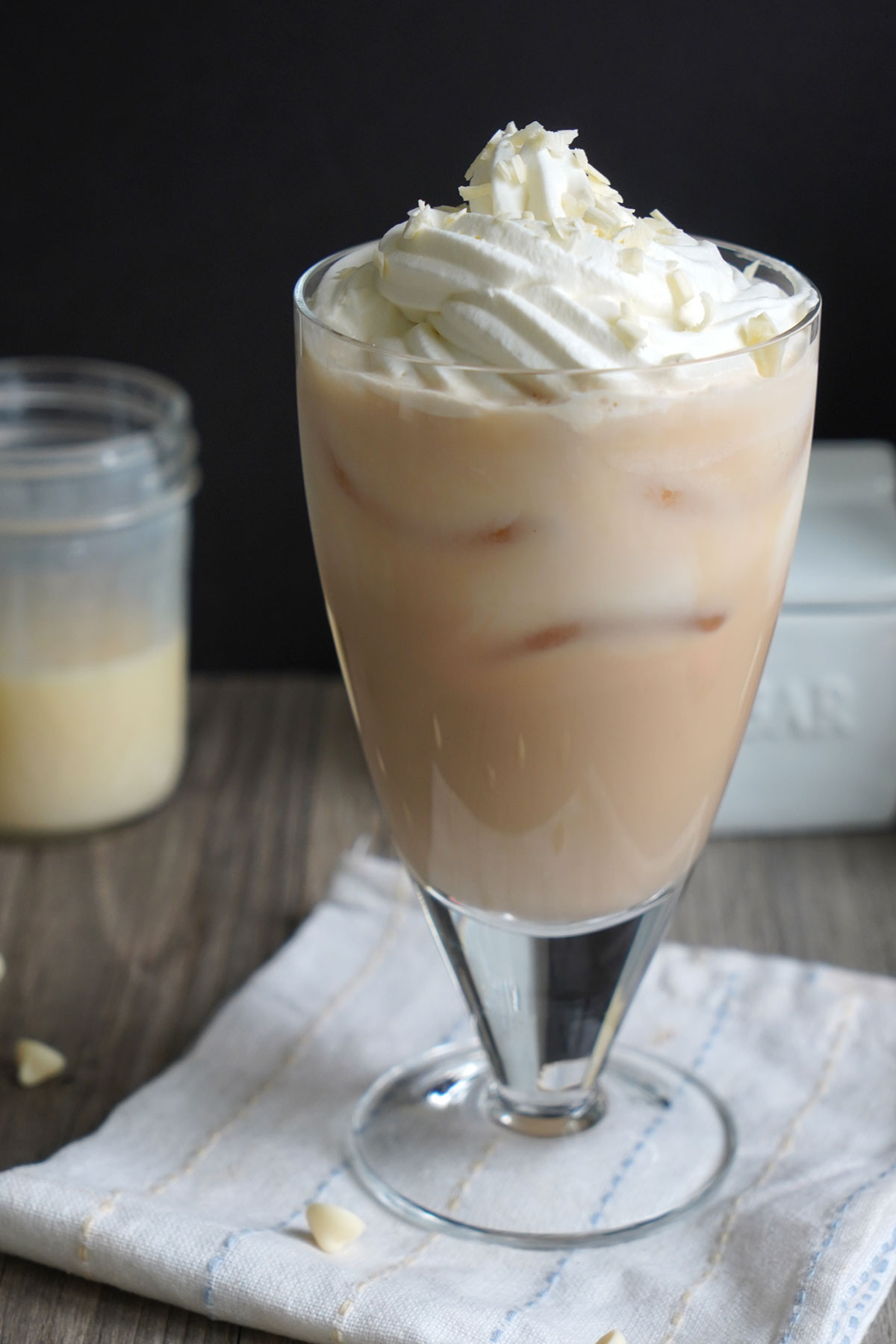 Iced White Chocolate Mocha Drink with whipped cream on top and shaved white chocolate.