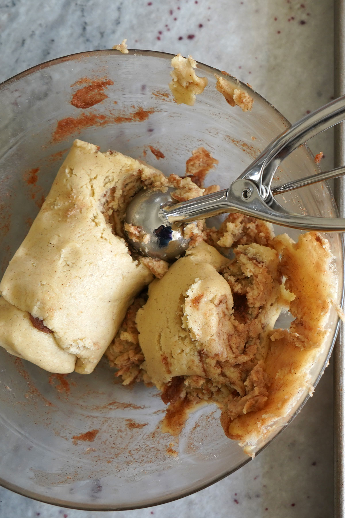 Dough being scooped from bowl.