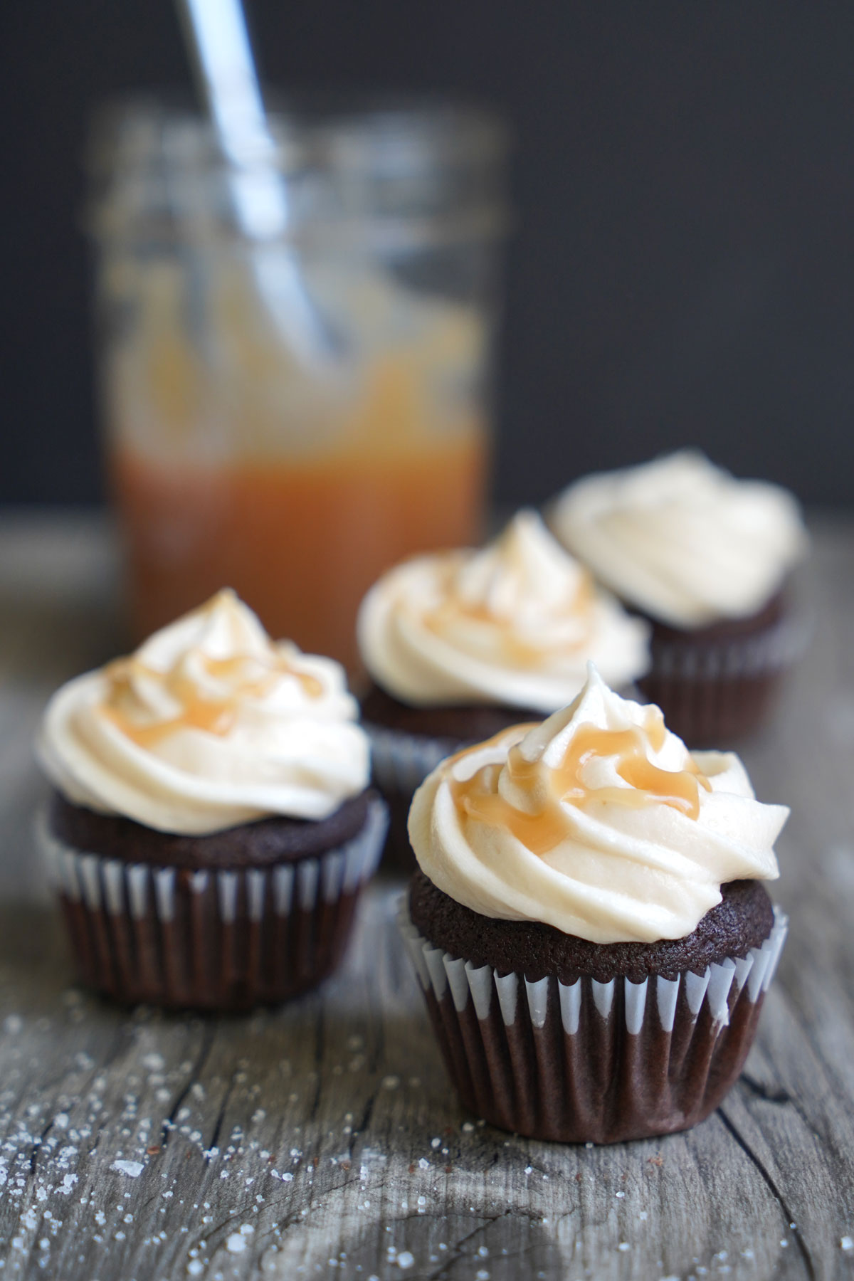 Cupcakes frosted with salted caramel frosting and drizzled with extra caramel sauce.