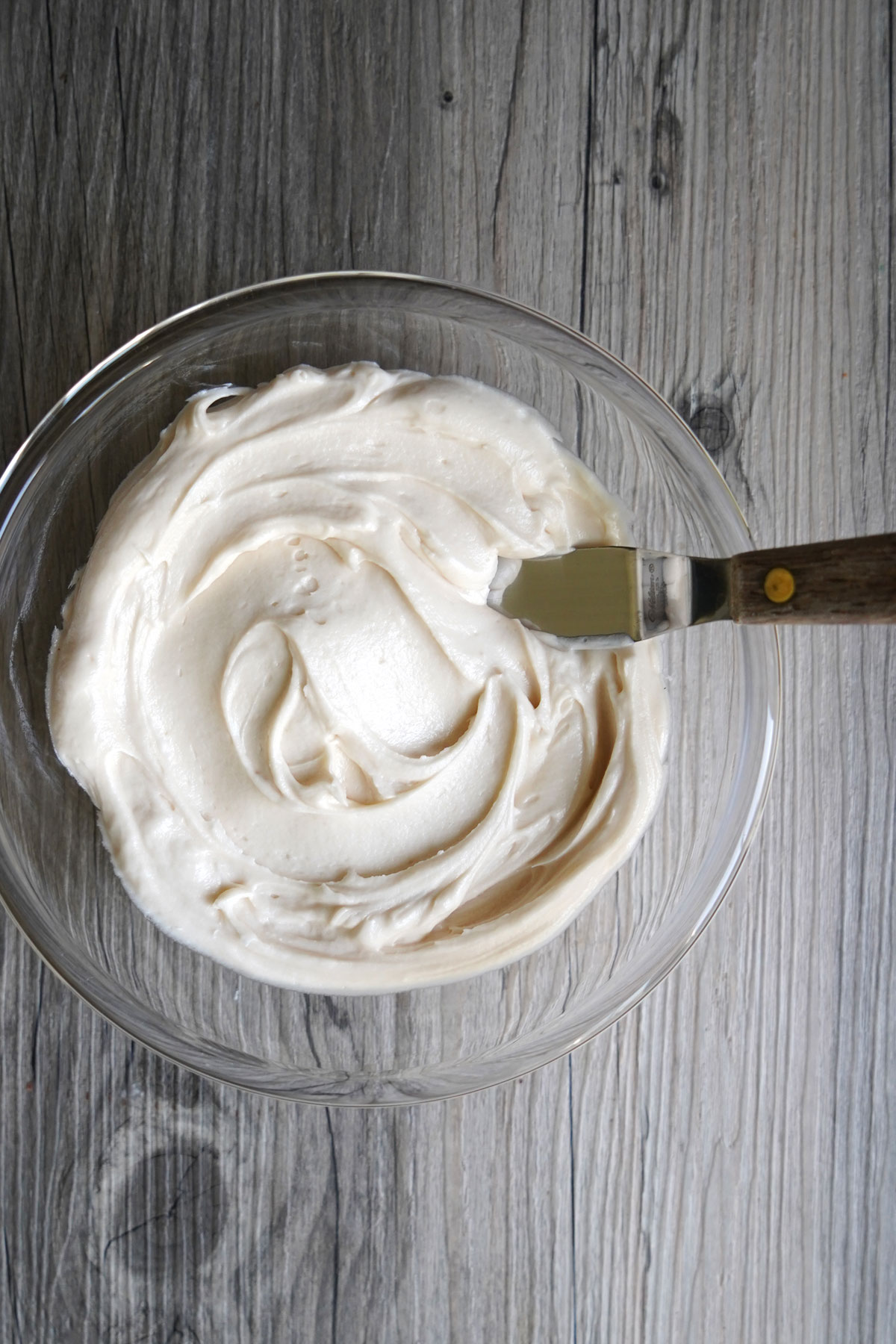 Top view of a bowl of salted caramel frosting.