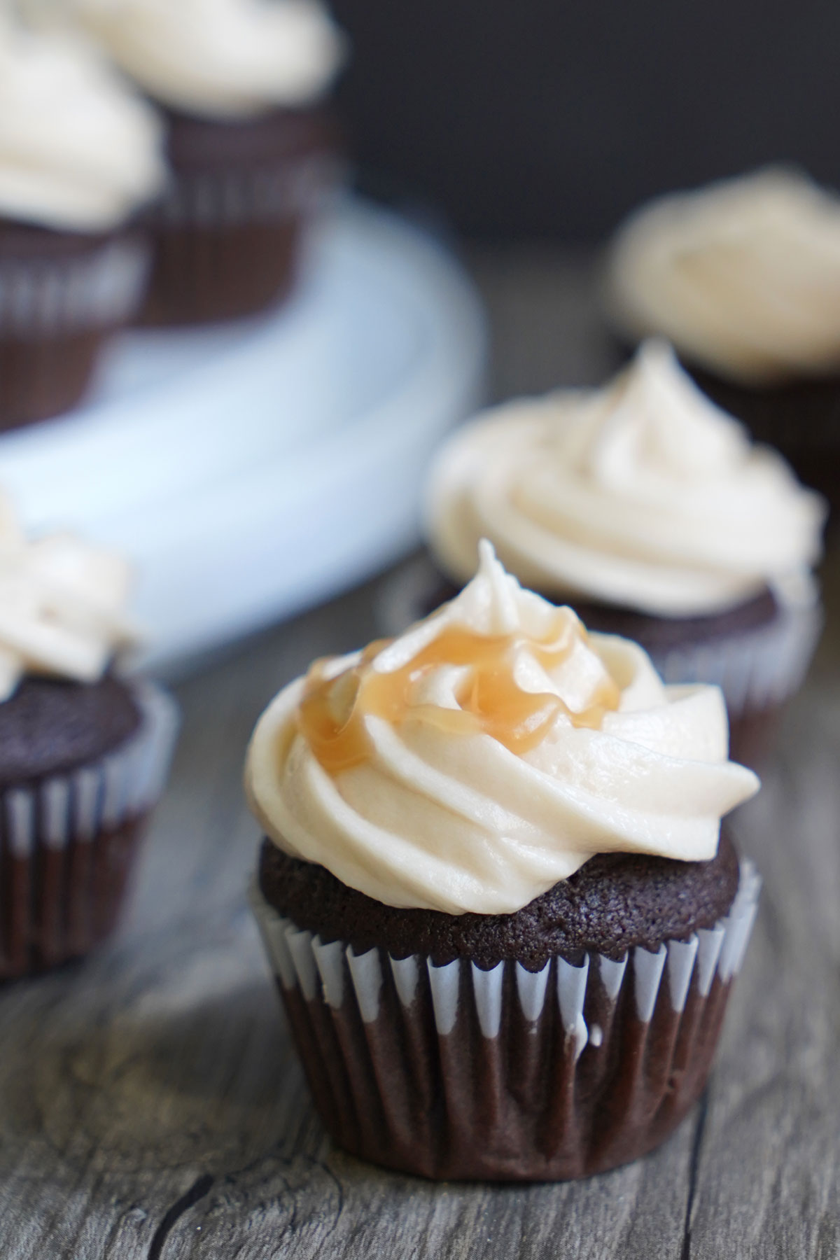 Chocolate cupcake topped with salted caramel frosting and drizzle of salted caramel sauce.