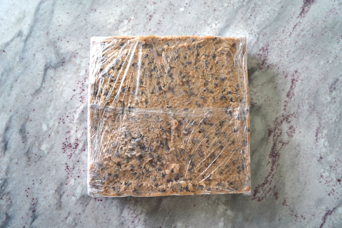 Cookie dough brownie slab wrapped in double plastic for freezing. 