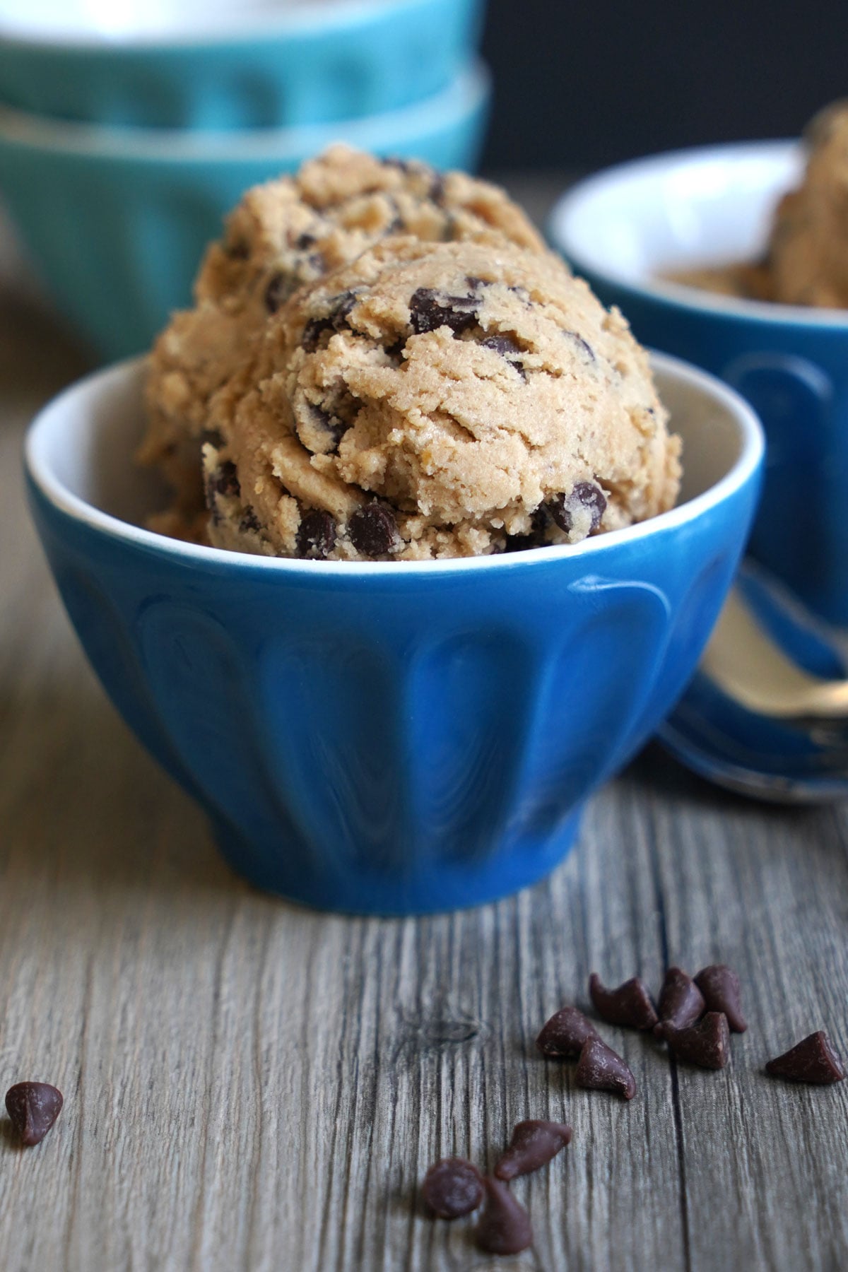 Bowl filled with scoops of edible cookie dough made with oat flour and mini chocolate chips.