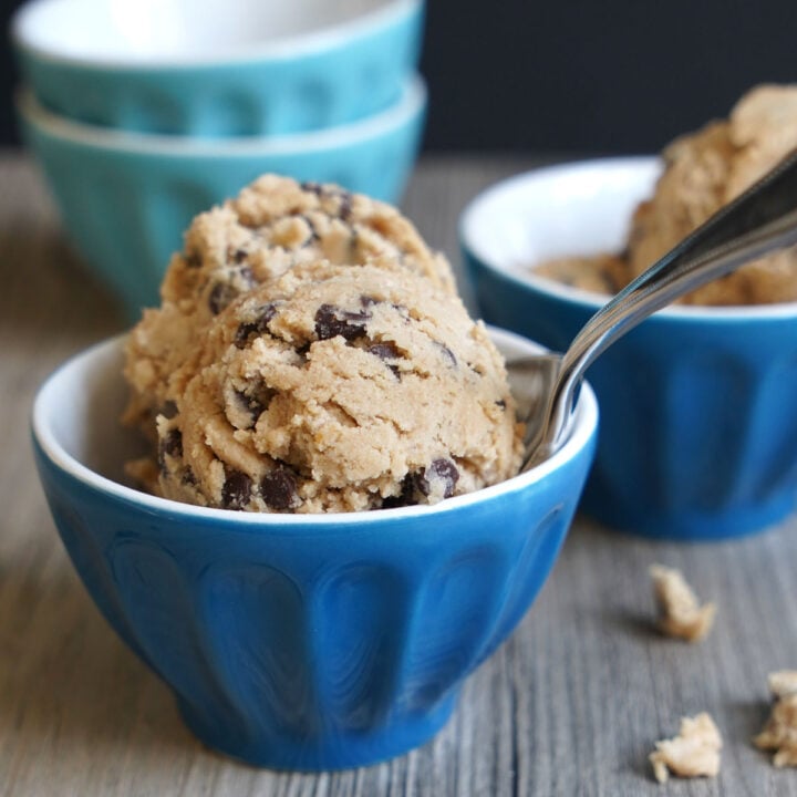 Bowl filled with scoops of edible cookie dough made with oat flour and mini chocolate chips.