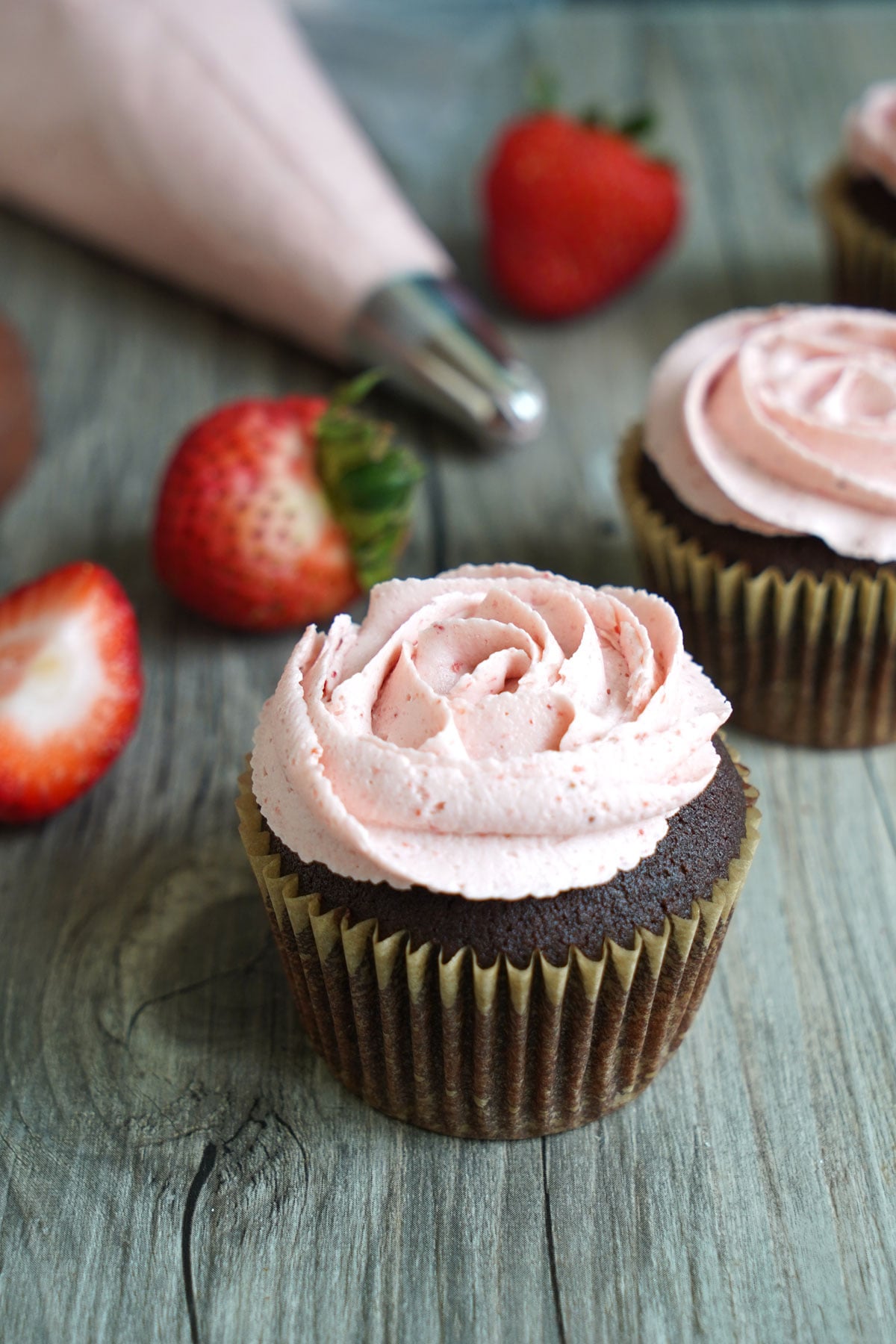 Chocolate cupcake frosted with strawberry frosting to show alternative way to serve cupcakes.