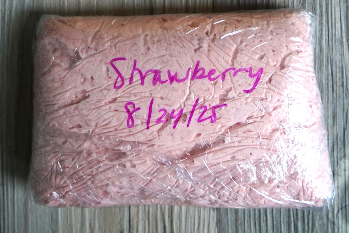 Strawbery buttercream double wrapped in plastic for freezer storage. 