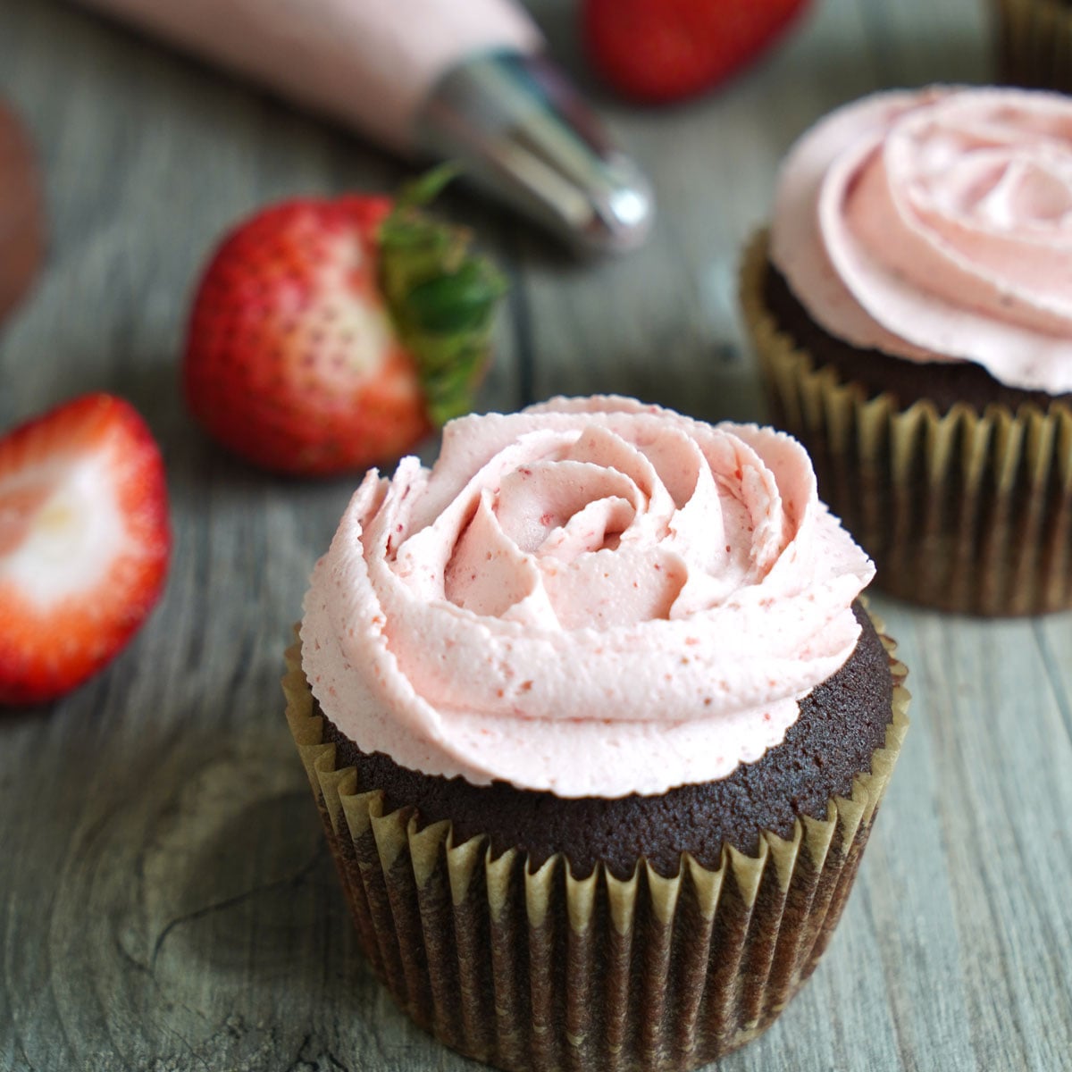 Chocolate cupcake with strawberry buttercream piped in a rose design.