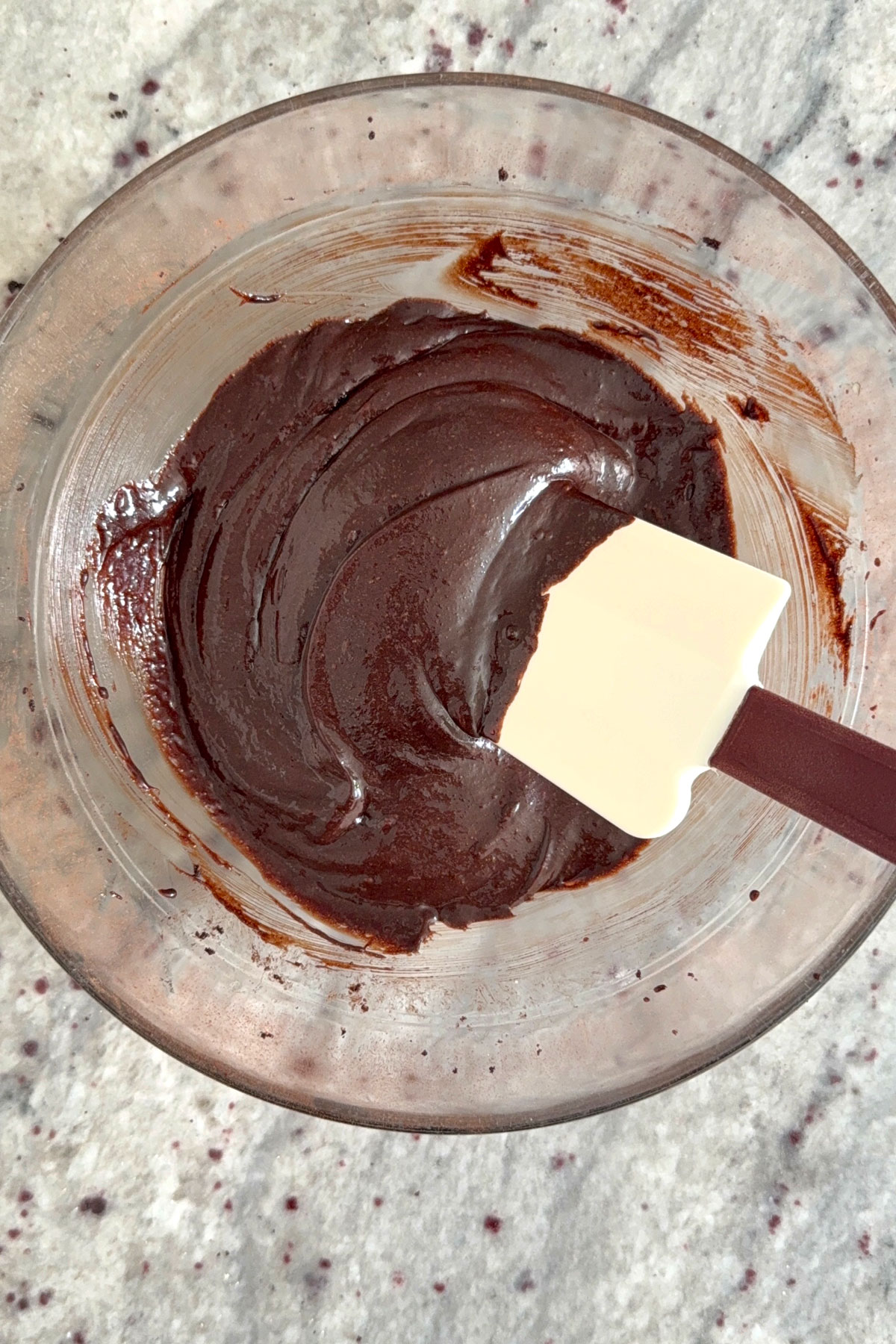 Chocolate crinkle cookie batter in glass bowl.