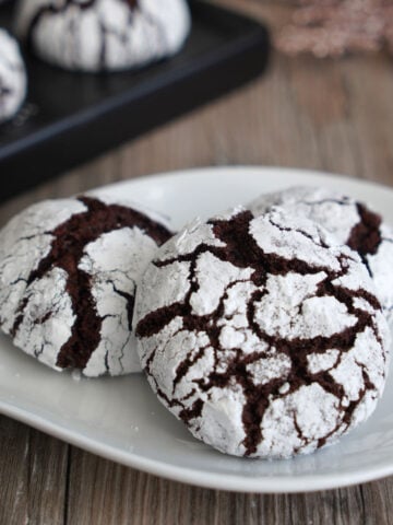 Close up of chocolate crinkle cookie showing off beautiful crackly top.