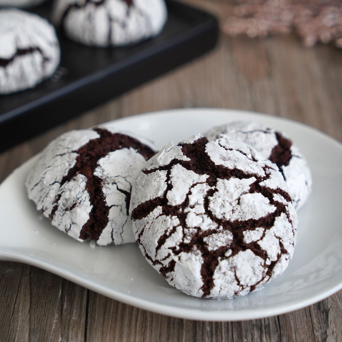 Close up of chocolate crinkle cookie showing off beautiful crackly top.