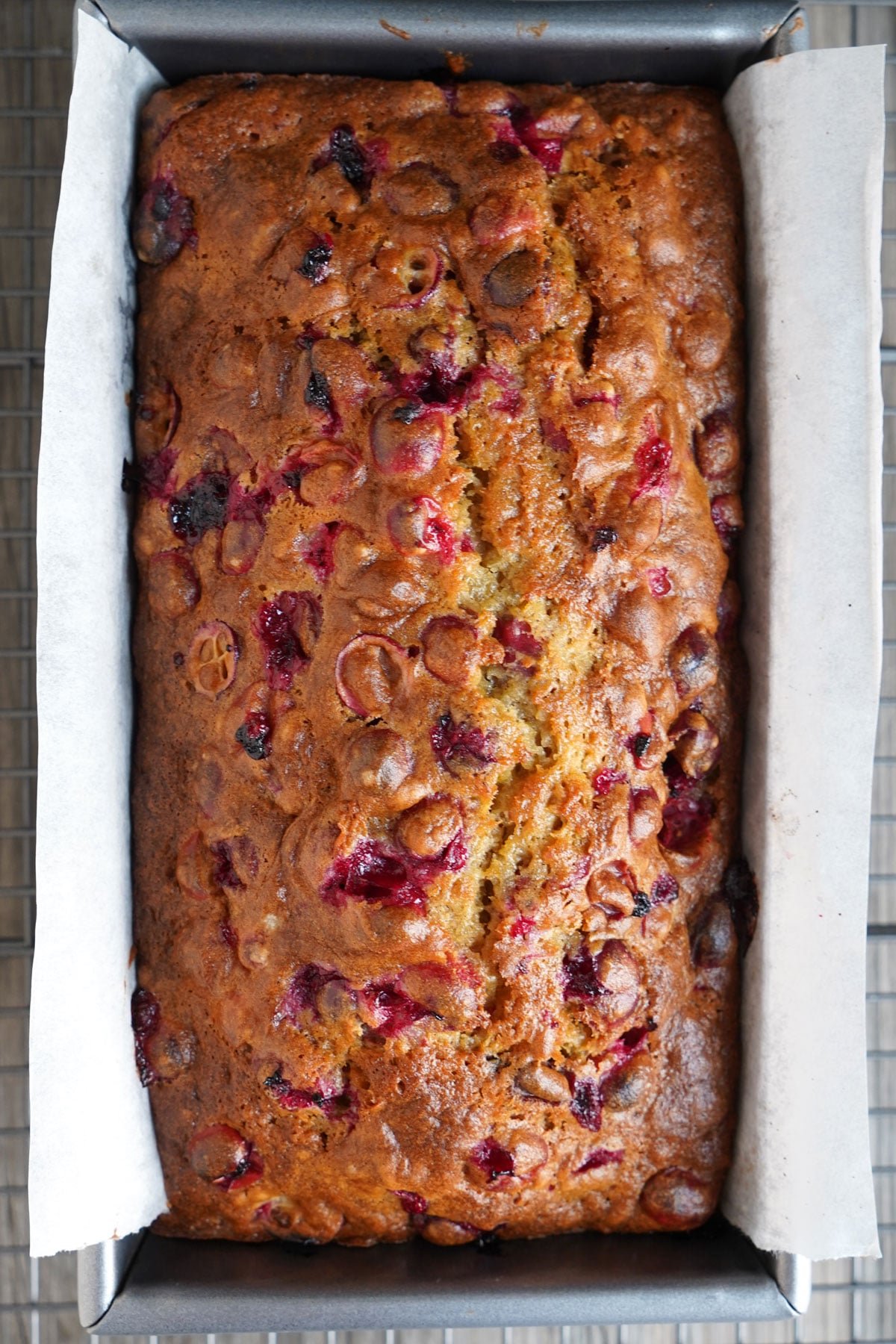 Spiced orange cranberry bread cooling in pan.