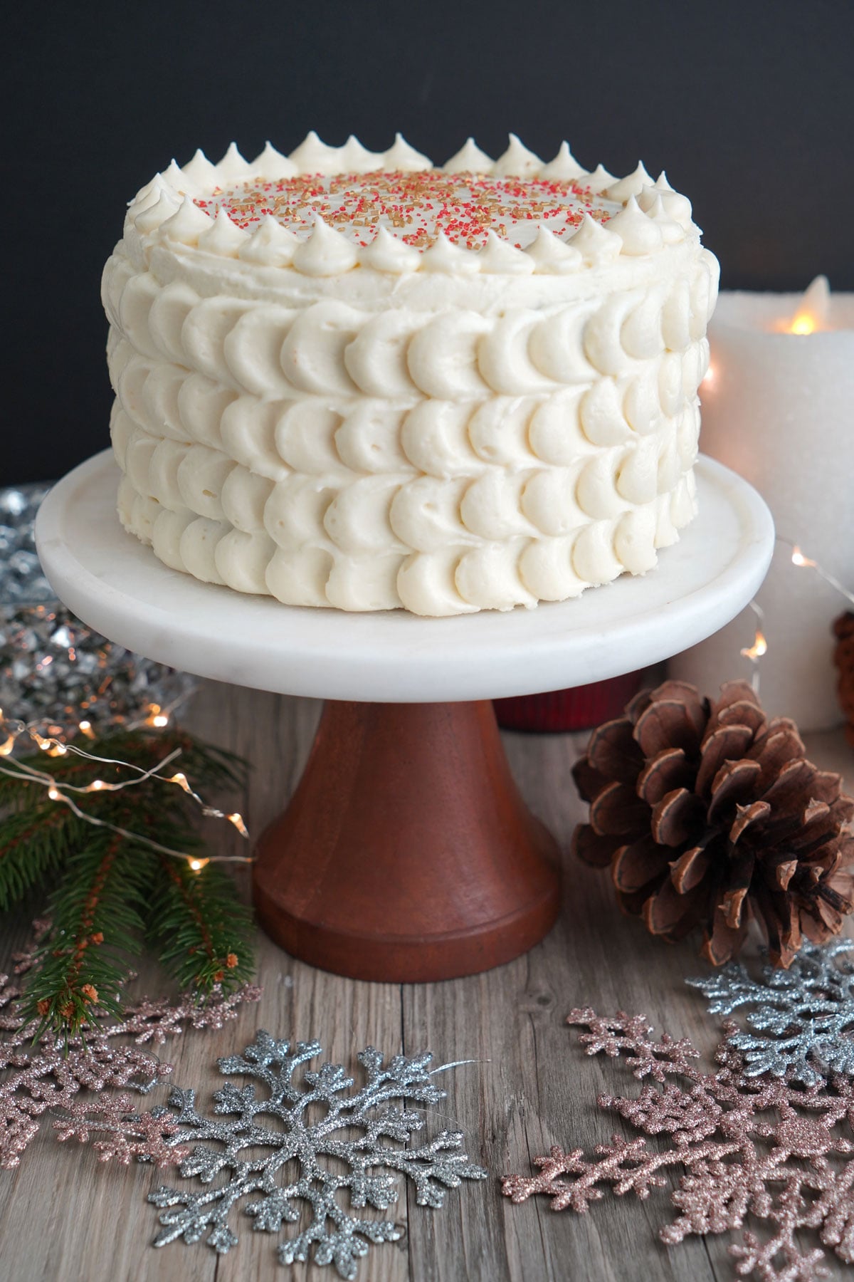 Frosted gingerbread cake on a pedestal. 