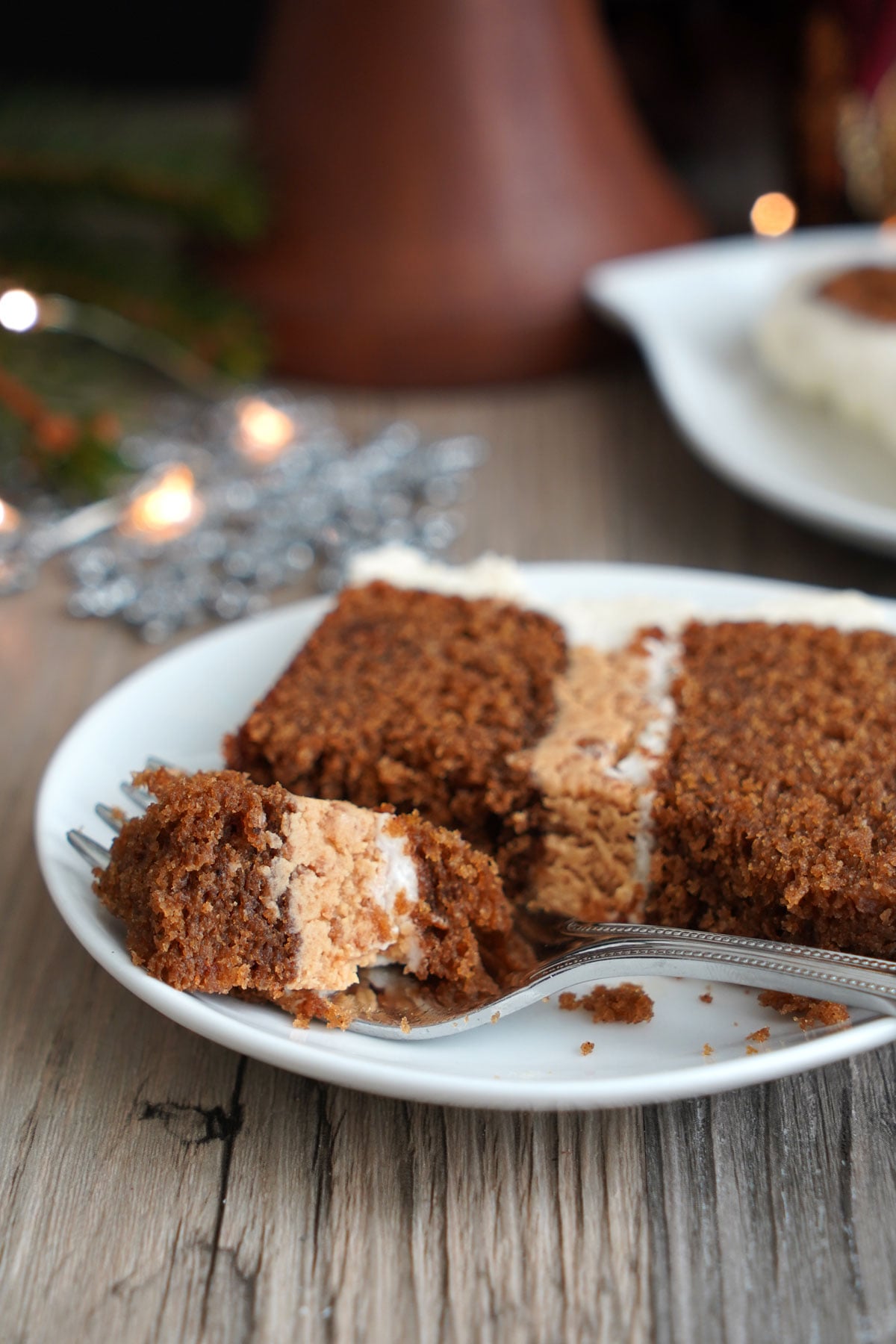 Slice of gingerbread cake with bite on a fork.