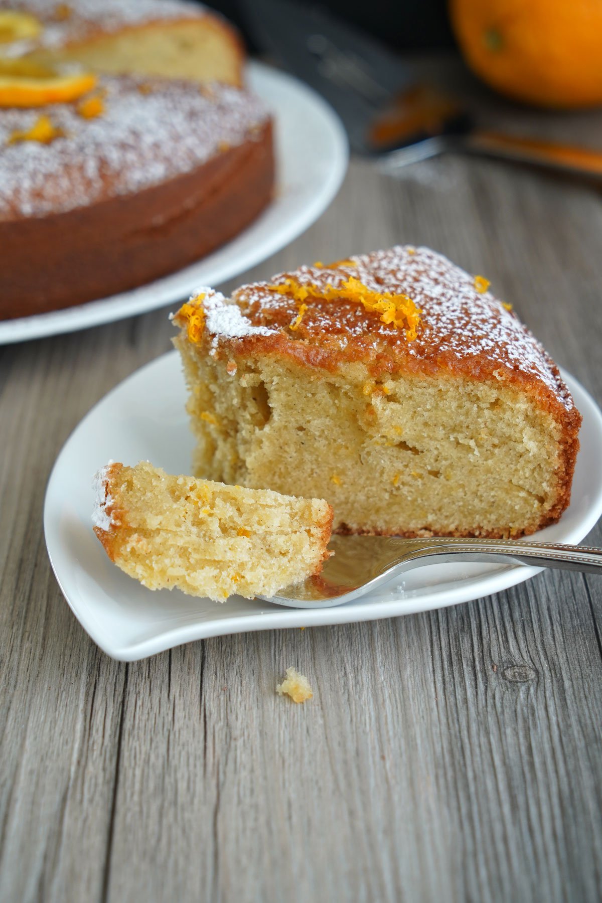 Fork bite of orange olive cake.