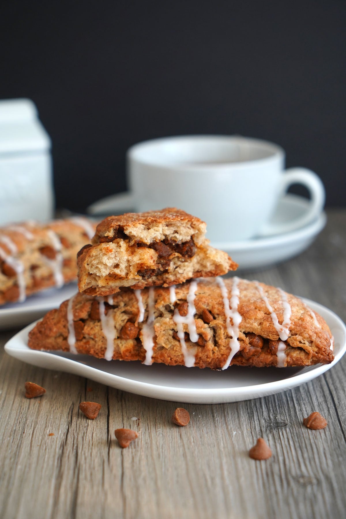 Broken cinnamon scone stacked on top of another scone to show inside texture of scone. 