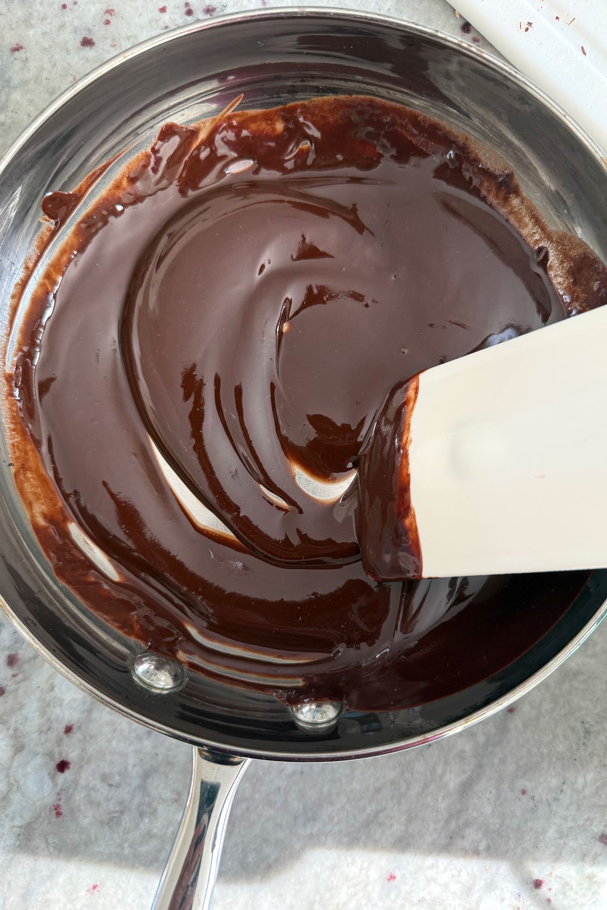 Melted butter and chocolate cooling in a pan.