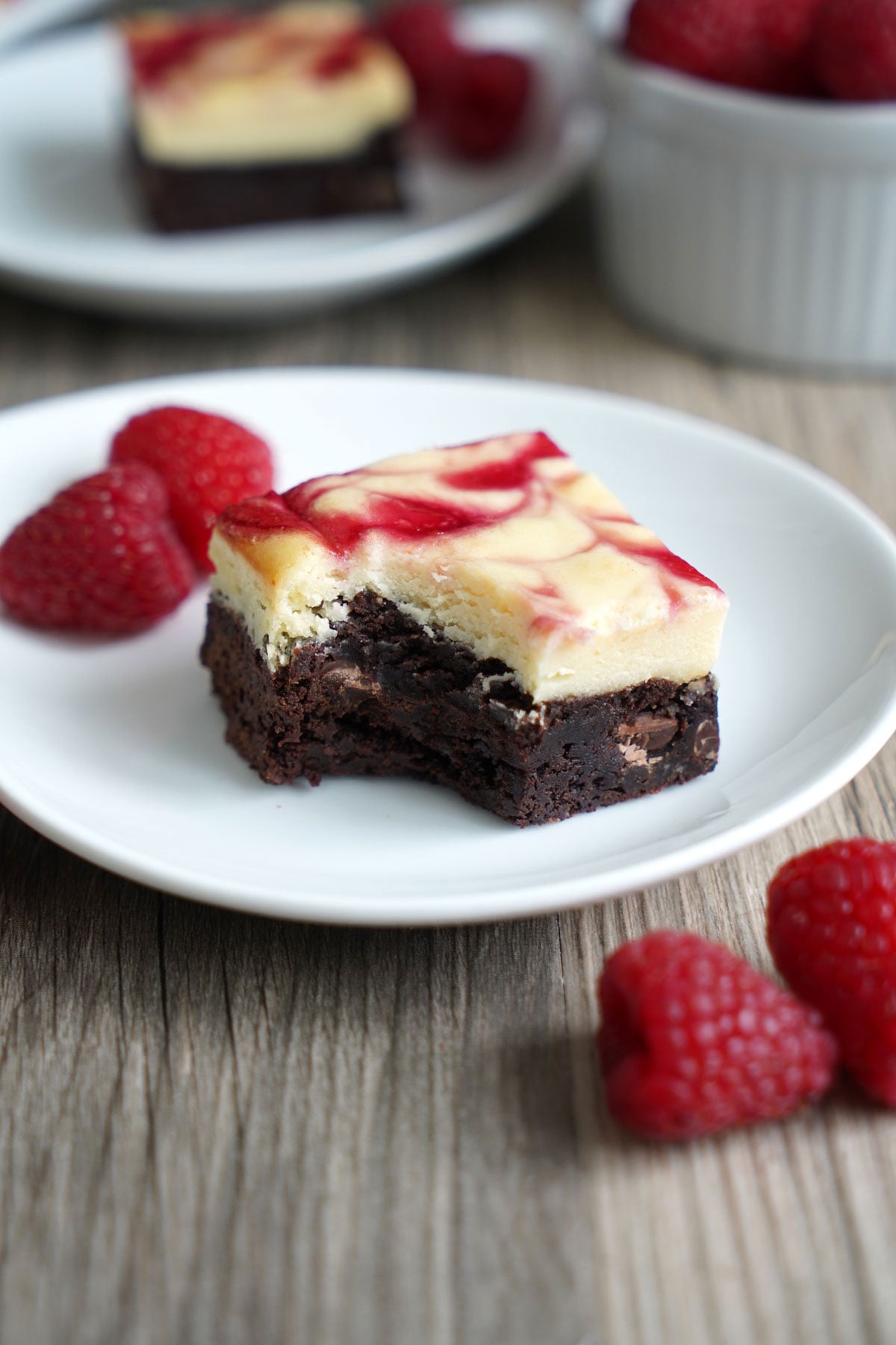 Raspberry cheesecake brownie with bite taken to show texture.