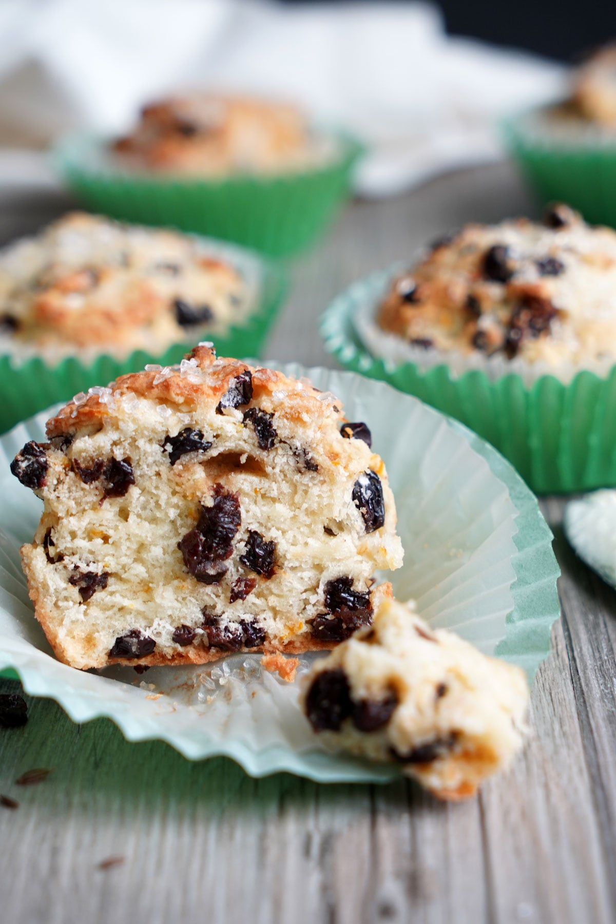 Irish soda bread muffin cut open showing interior crumb and currants. 