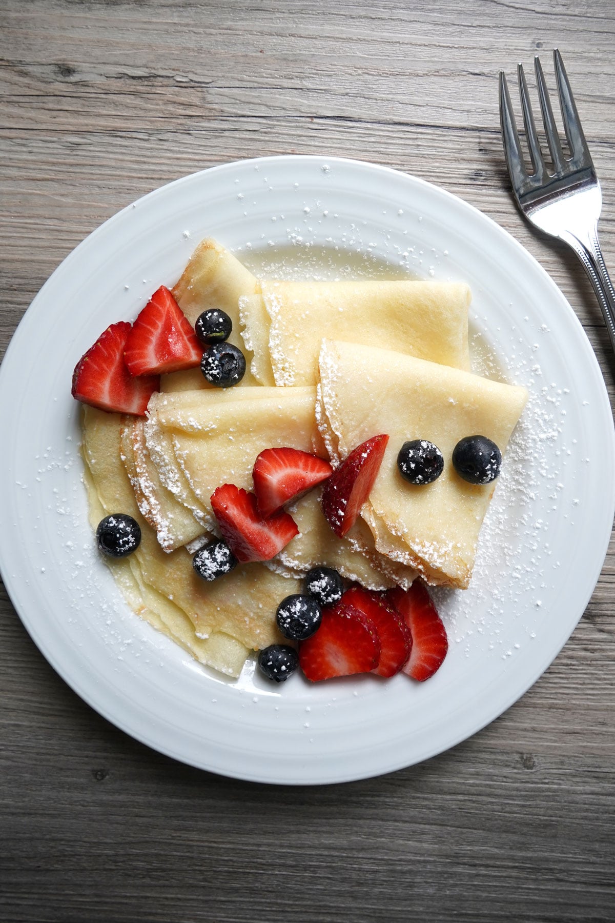 Pancake mix crepes folded into triangles, dusted with powder sugar and served with fresh berries.