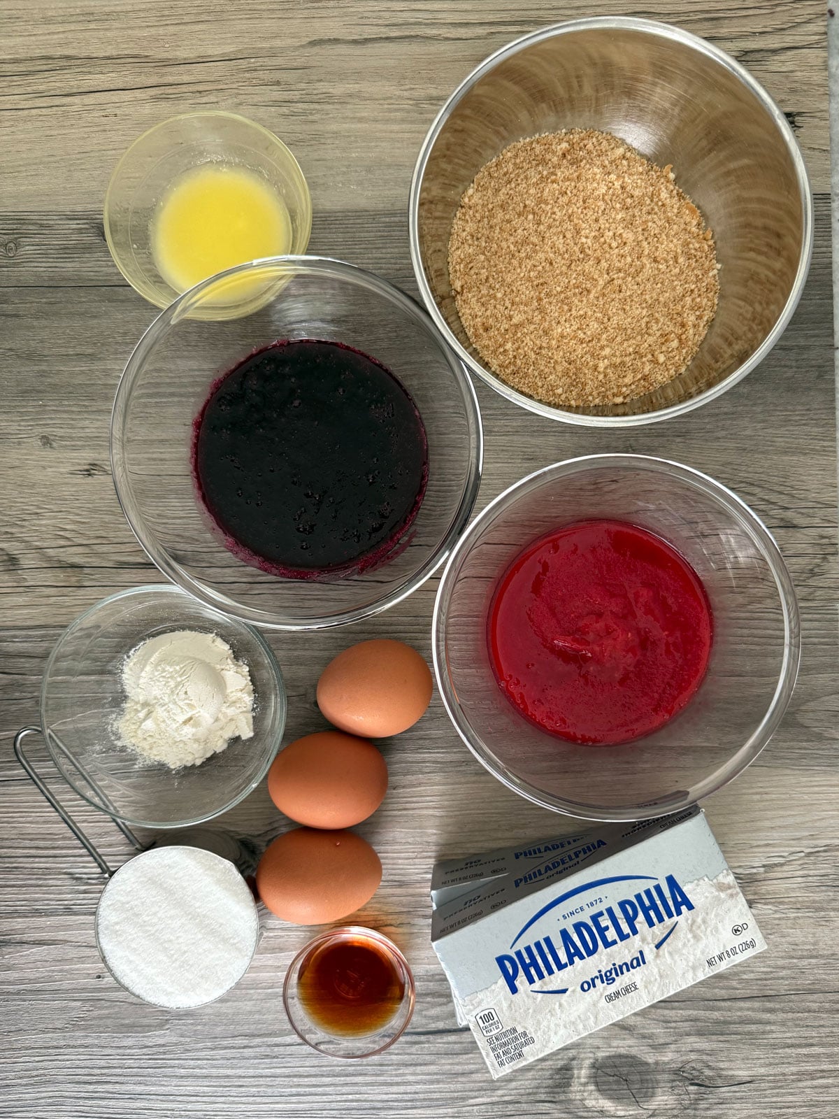 Flat lay view of ingredients needed for red white blue cheesecake bars.