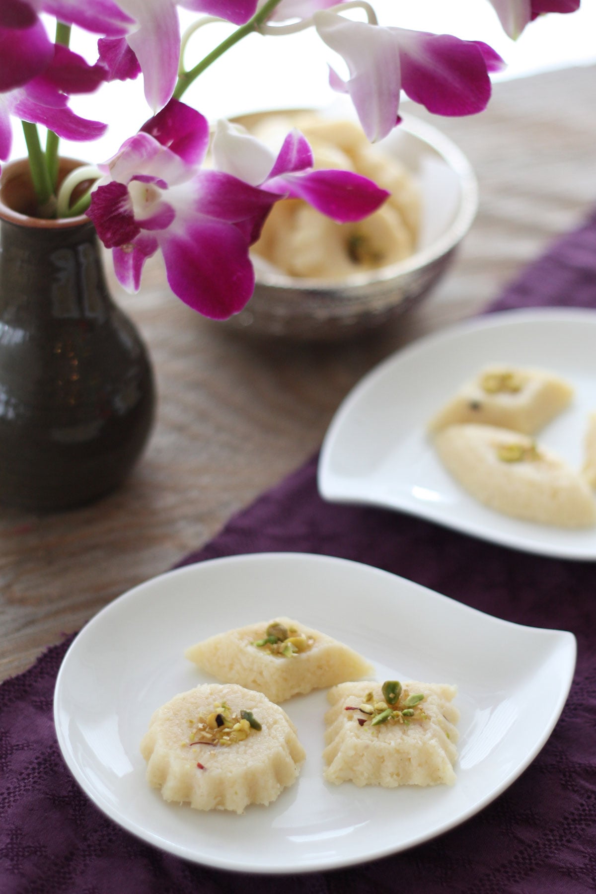 Nariyal ki barfi pieces in a white dish.