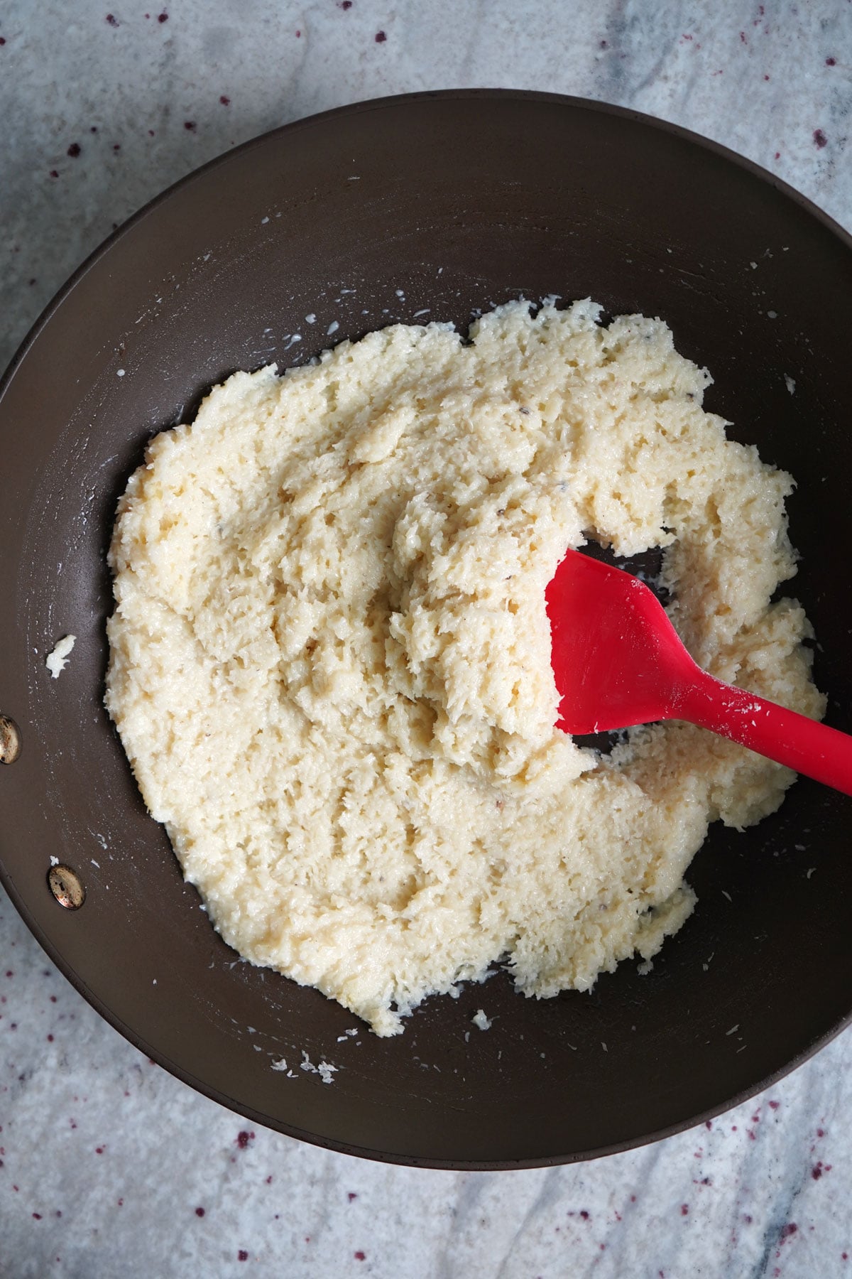 Coconut mixture pulling away from the side of the pan.