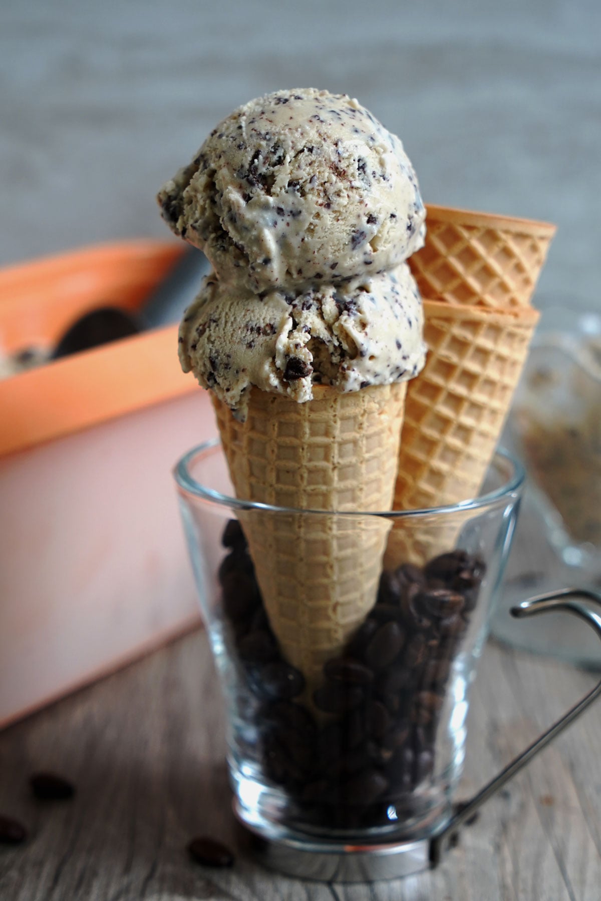 Two scoops of espresso chocolate chip ice cream in a cone.