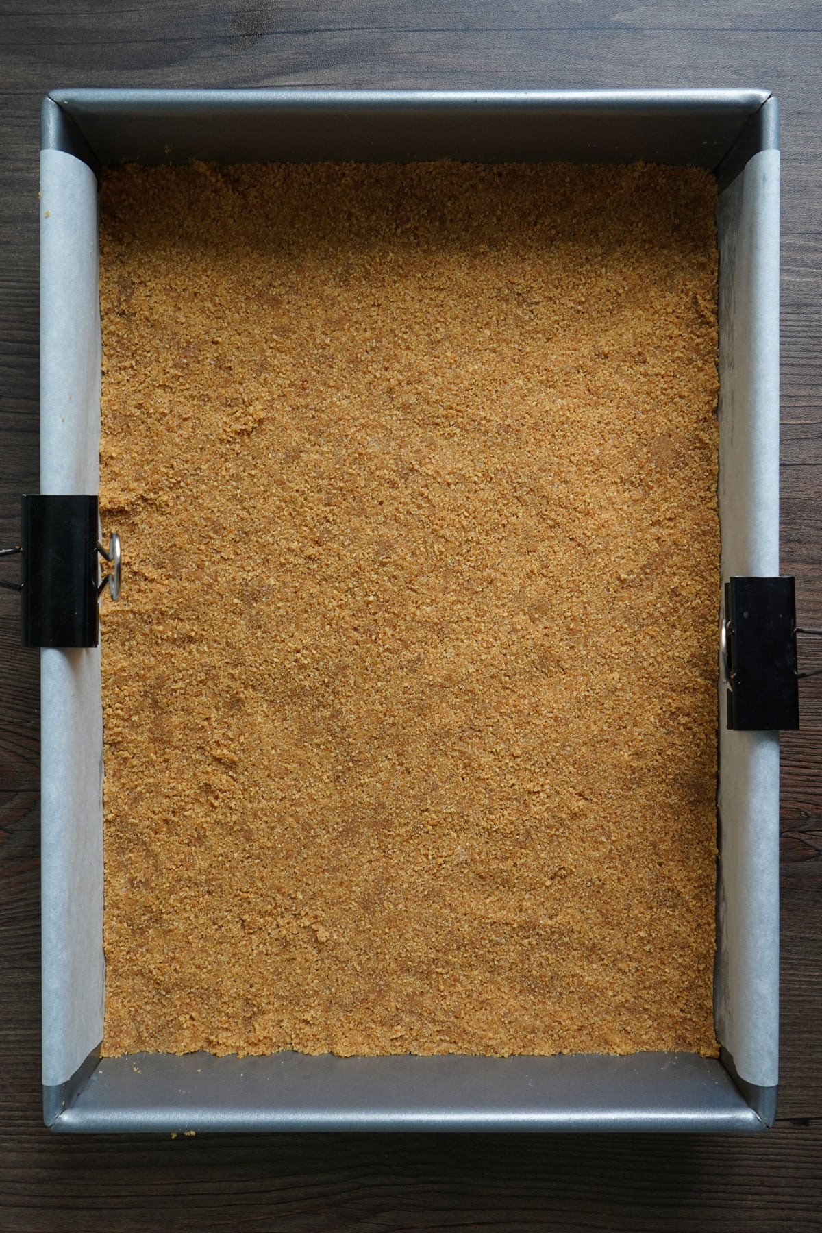 Graham cracker crust pressed into a 9x13, making the base of chocolate chip paradise pie.