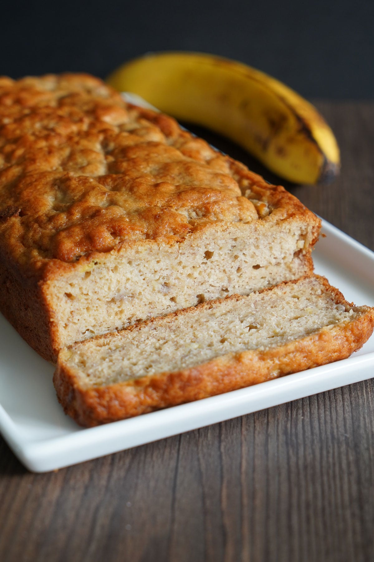 Pancake mix banana bread with one piece sliced off to show crumb.